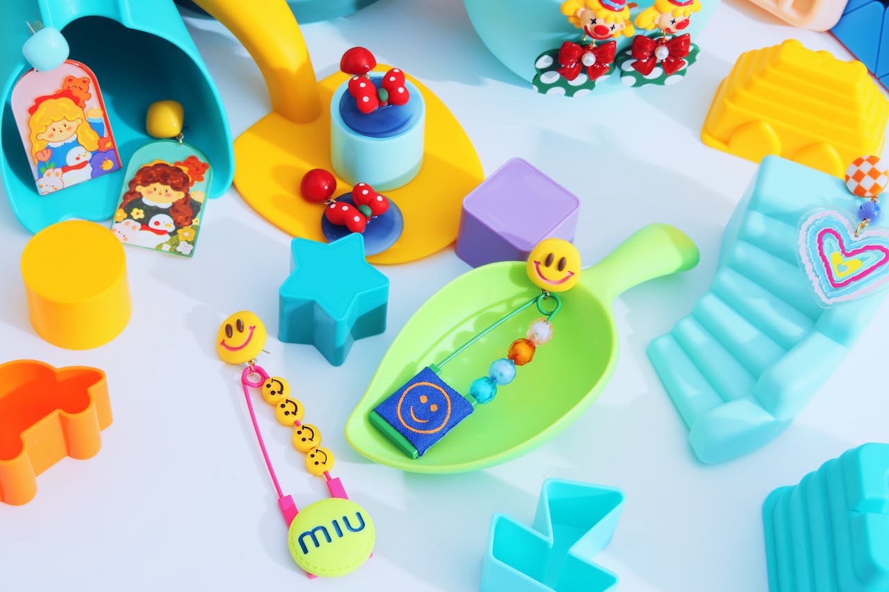 Vibrant collection of playful plastic toys and accessories on a white surface.